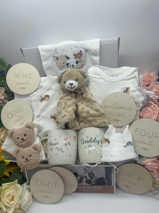 Baby gift set with teddy bears, clothes, and decorative items