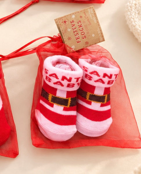 Santa Baby Christmas baby booties with a red and white Santa suit design in a red organza gift bag