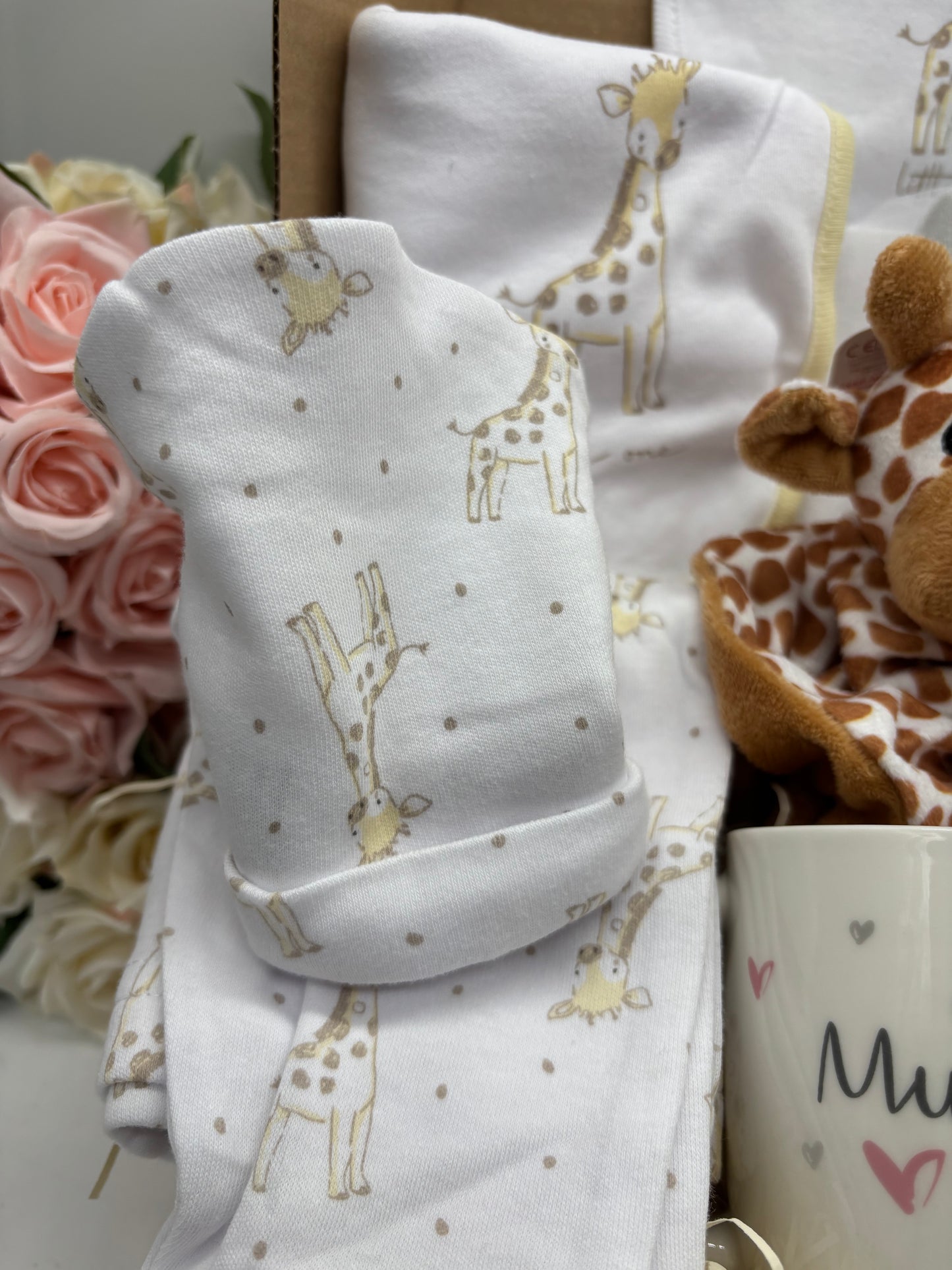 Giraffe print baby hat and sleepsuit from the new baby gift box