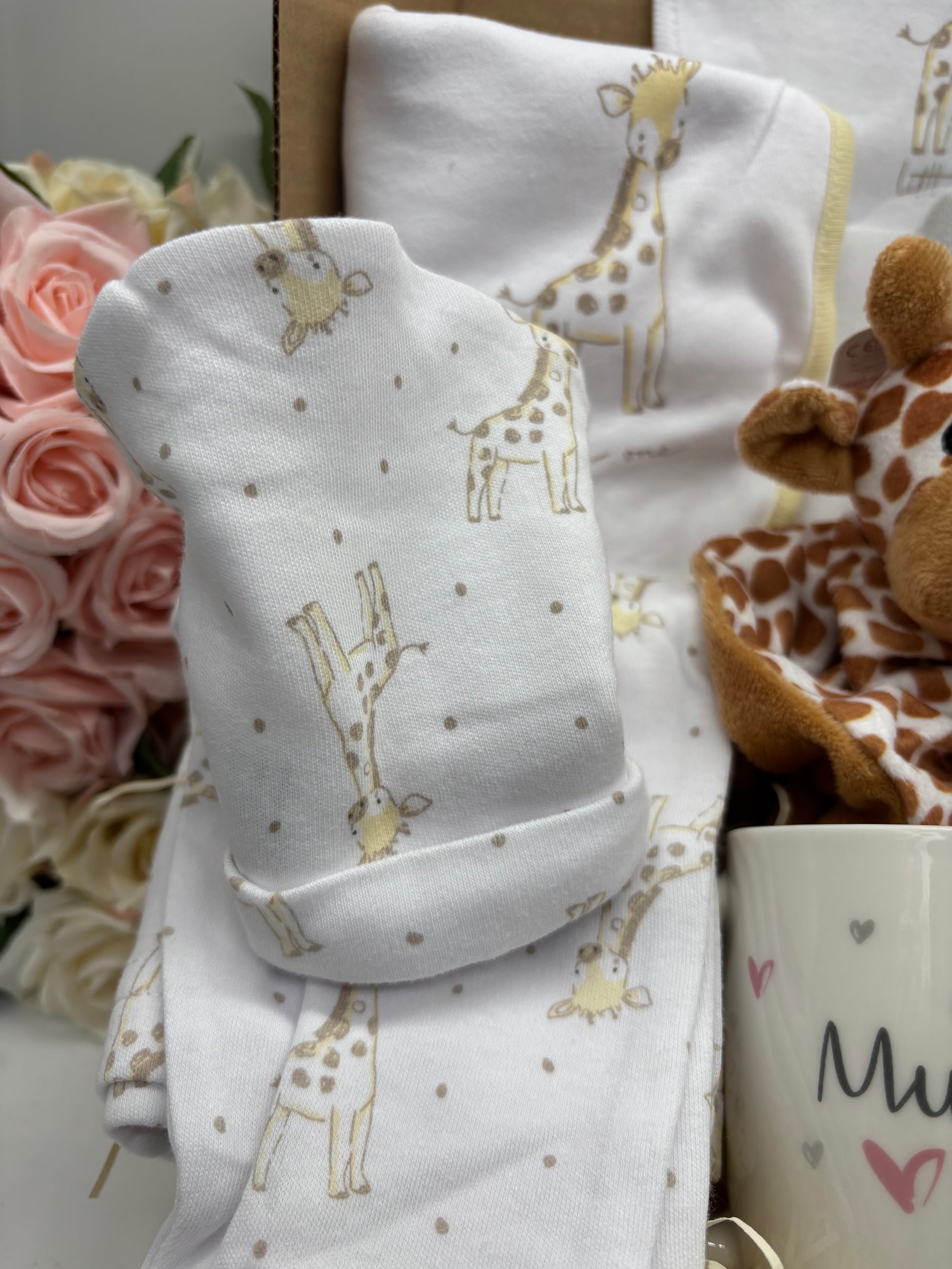 Giraffe print baby hat and sleepsuit from the new baby gift box