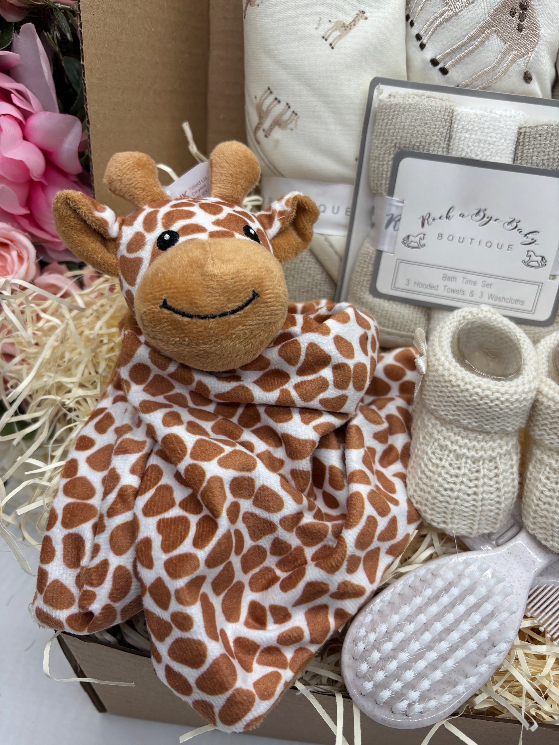 Giraffe comforter, cream knitted booties and baby hairbrush in the giraffe gift box