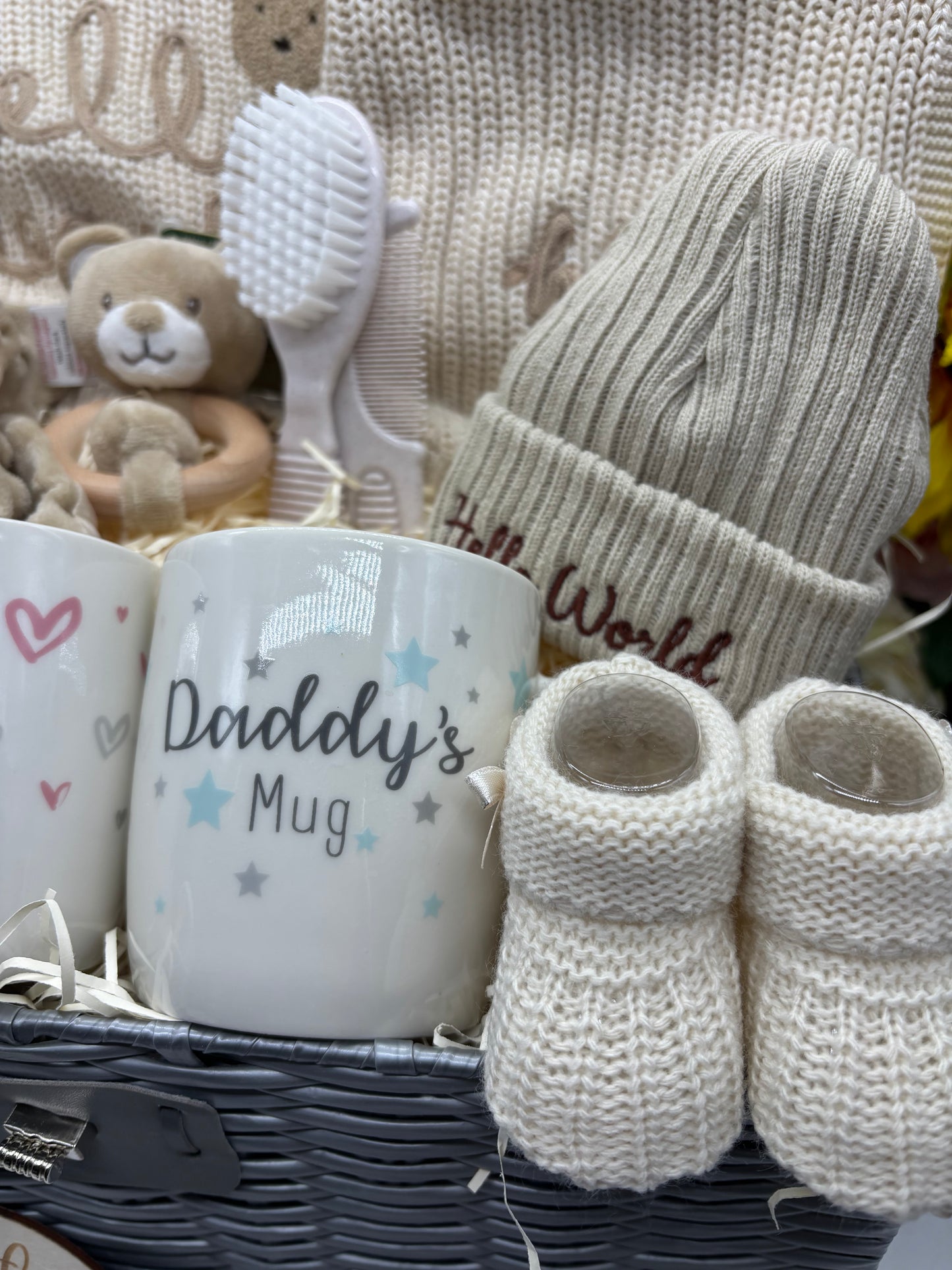 Daddy's Mug, cream knitted booties, Hello World hat and teddy rattle in the neutral baby hamper