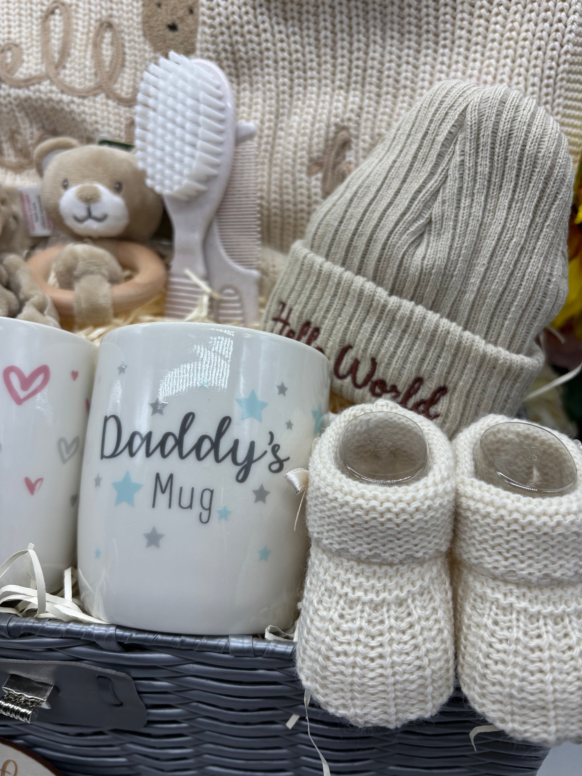Daddy's Mug, cream knitted booties, Hello World hat and teddy rattle in the neutral baby hamper
