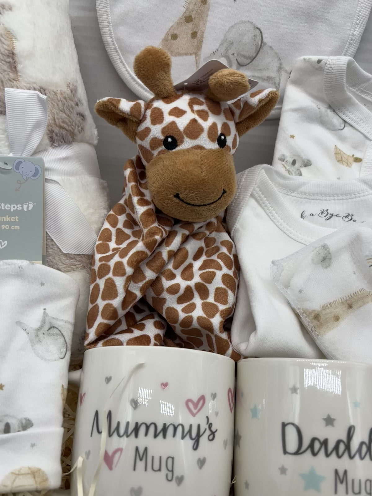 New Baby Gift Box for New Parents, Mummy and Daddy Mugs, Baby Clothes, Giraffe Comforter and Knitted Booties