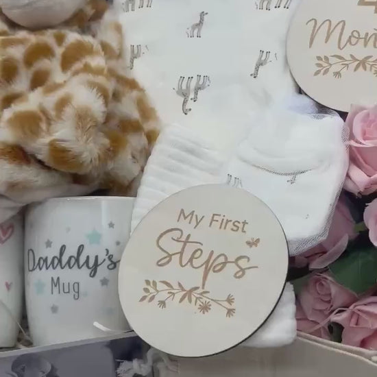 Neutral giraffe baby gift box with giraffe clothing, comforter, booties, mugs and milestone discs
