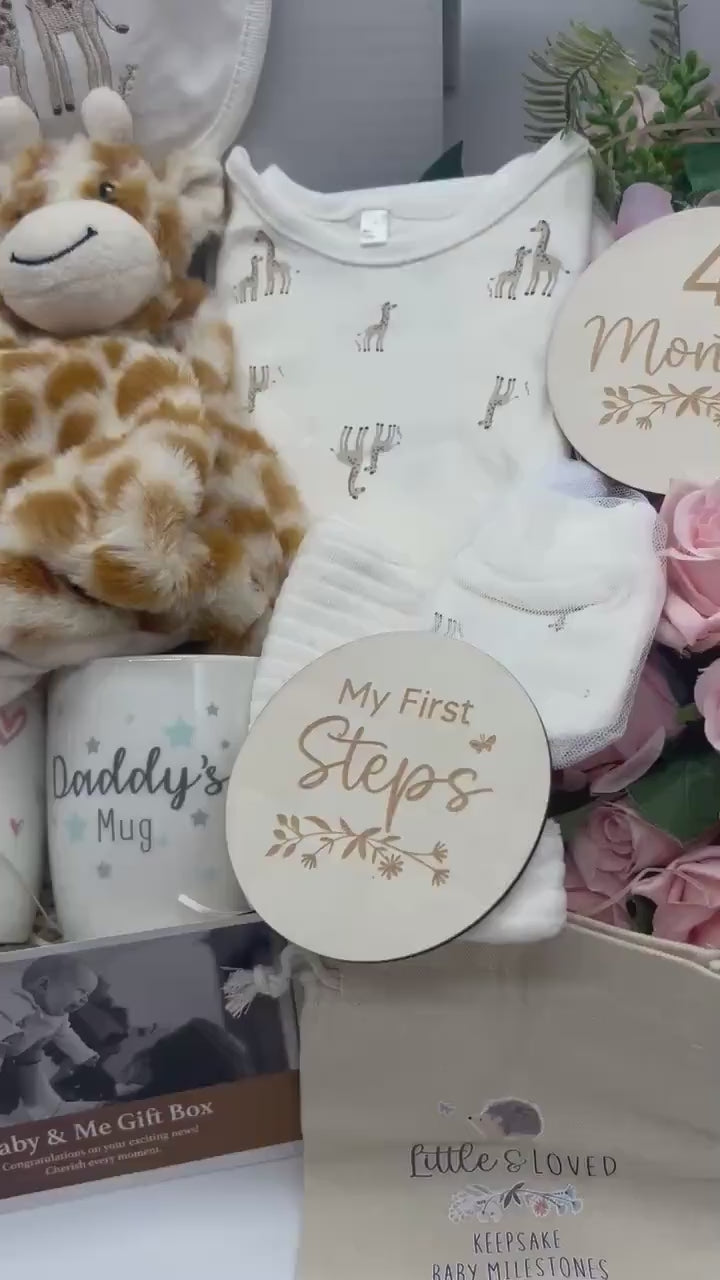 Neutral giraffe baby gift box with giraffe clothing, comforter, booties, mugs and milestone discs