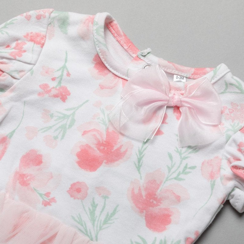 Close-up of the pink floral print and chiffon bow on the baby girl tutu bodysuit